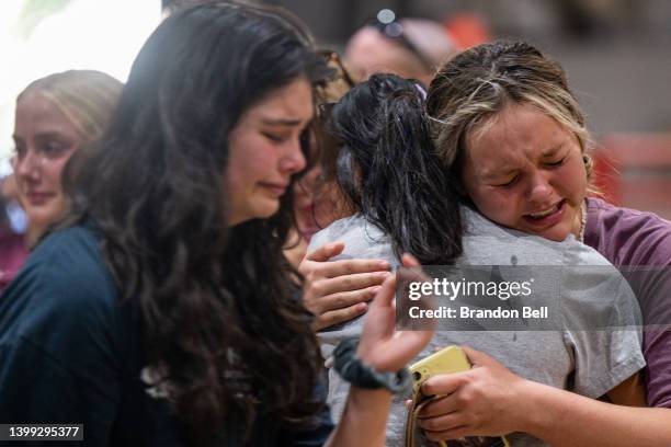 Community members mourn together at a vigil for the 21 victims in the mass shooting at Robb Elementary School on May 25, 2022 in Uvalde, Texas....