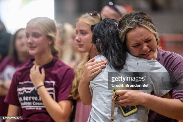 Community members embrace and mourn together at a vigil for the 21 victims in the mass shooting at Robb Elementary School on May 25, 2022 in Uvalde,...