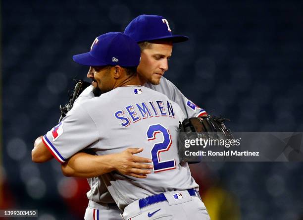 Corey Seager and Marcus Semien of the Texas Rangers celebrate a 7-2 win against the Los Angeles Angels at Angel Stadium of Anaheim on May 25, 2022 in...