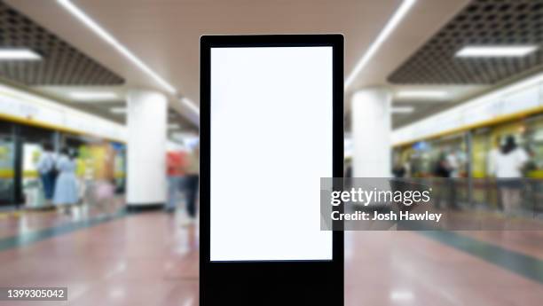 blank billboard on the subway station - billboard photos et images de collection