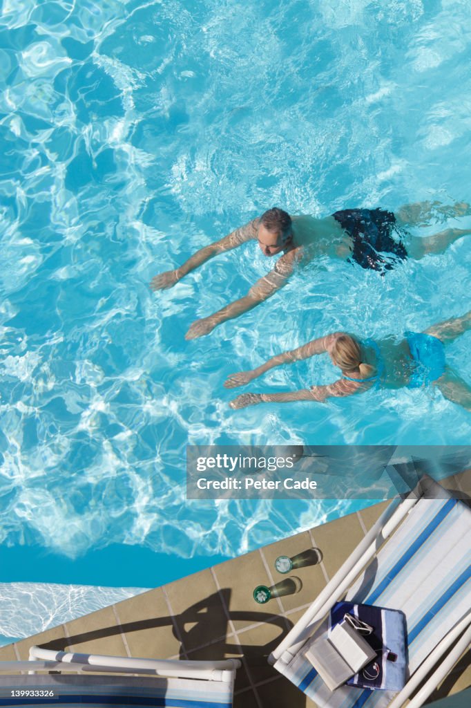 Couple swimming in pool