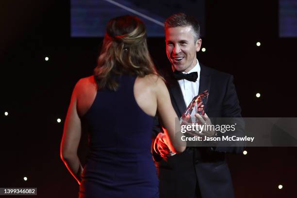 Former Brisbane Roar and Socceroos player Matt McKay presents Lara Lee with the Women's Referee of the Year award during the 2022 Dolan Warren Awards...