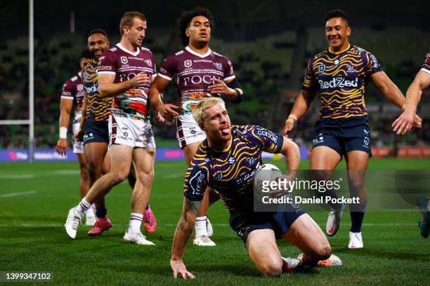 Cameron Munster of the Storm celebrates scoring a try during the round 12 NRL match between the Melbourne Storm and the Manly Sea Eagles at AAMI...