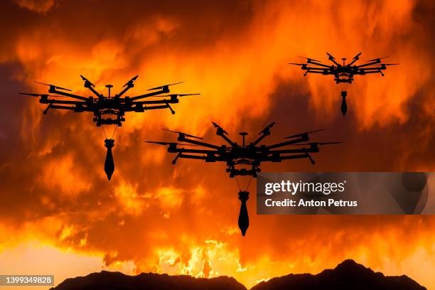 military drone with a bomb at sunset. attack drone in military conflicts - drone foto e immagini stock