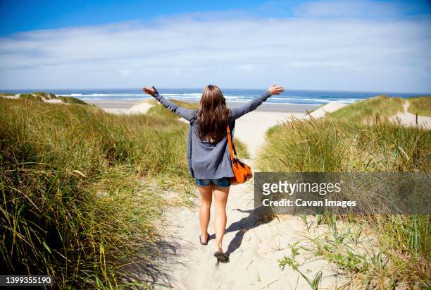 a young woman arrives at the beach - tillamook county stock pictures, royalty-free photos & images