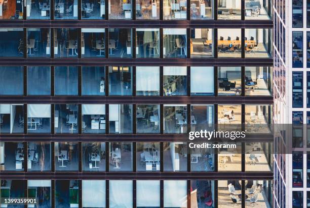 corporate building facade in windows of glass and steel - office building stockfoto's en -beelden