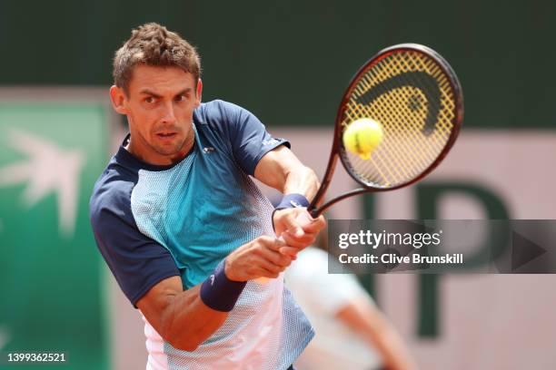 Henri Laaksonen of Switzerland plays a backhand against Holger Rune of Denmark during the Men's singles Second Round on Day Five of the 2022 French...