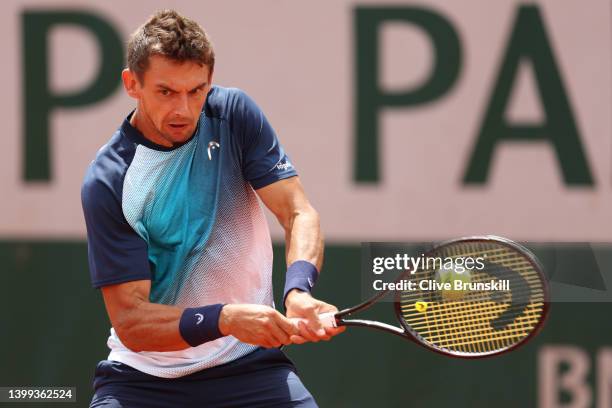 Henri Laaksonen of Switzerland plays a backhand against Holger Rune of Denmark during the Men's singles Second Round on Day Five of the 2022 French...