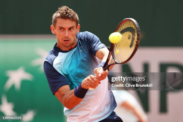 Henri Laaksonen of Switzerland plays a backhand against Holger Rune of Denmark during the Men's singles Second Round on Day Five of the 2022 French...