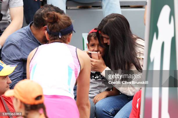Irina-Camelia Begu of Romania checks on a child she struck in the face with a ball during the Women's singles Second Round on Day Five of the 2022...