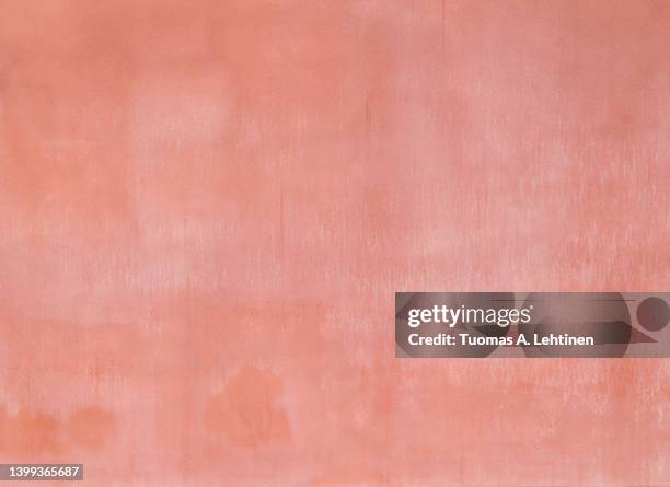 plastered, weathered and painted pinkish, reddish peach colored concrete wall. - peach colour stock pictures, royalty-free photos & images