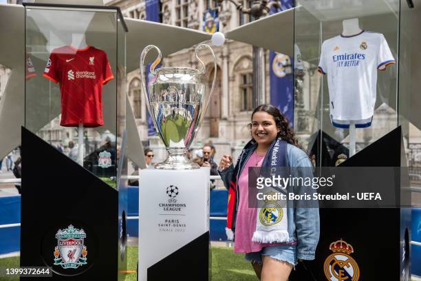 Fans pose with the UEFA Champions League trophy at Hotel de Ville on day 1 of the UEFA Champions League Final 2021/22 Festival ahead of the UEFA...