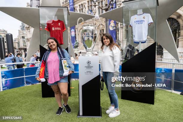 Fans pose with the UEFA Champions League trophy at Hotel de Ville on day 1 of the UEFA Champions League Final 2021/22 Festival ahead of the UEFA...