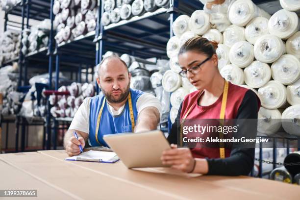 warehouse workers comparing digital tablet import numbers with items - leather industry stock pictures, royalty-free photos & images