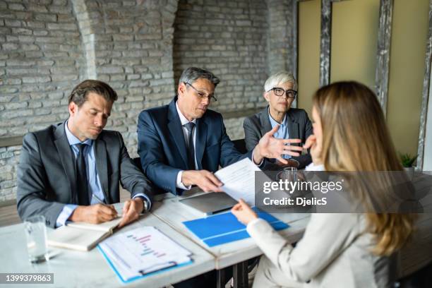 human resource team rejecting young female candidate on a job interview. - recusar imagens e fotografias de stock