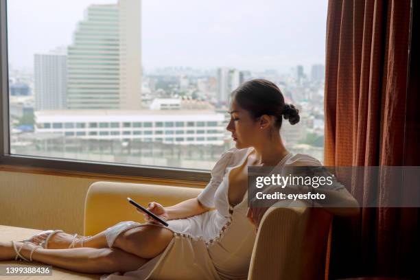 business woman is working at hotel room. - window frame stock pictures, royalty-free photos & images