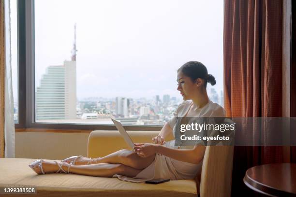 business woman is working at hotel room. - solo performance stock pictures, royalty-free photos & images