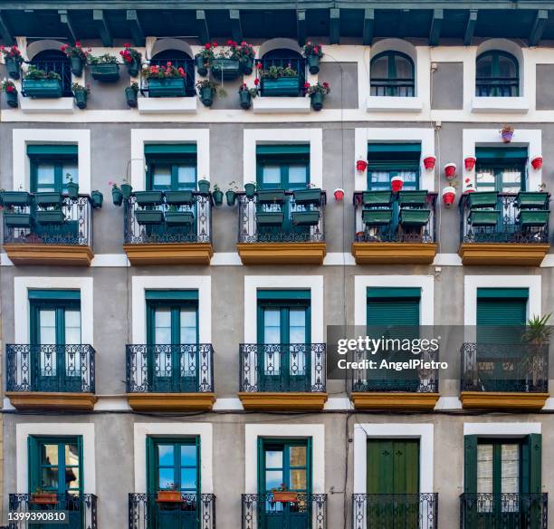 a facade with 15 windows - hondarribia stock-fotos und bilder