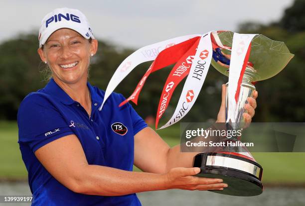 Angela Stanford of the USA celebrates with the trophy after winning the HSBC Women's Champions on the third playoff hole during the final round of...