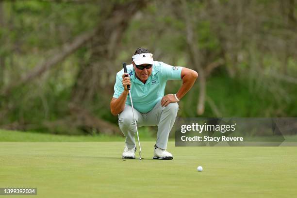 Robert Allenby of Australia lines up a putt on the first green during the first round of the Senior PGA Championship presented by KitchenAid at...