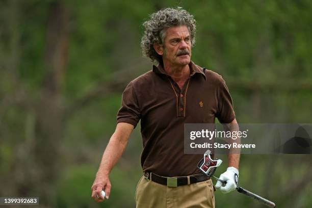 Jesper Parnevik of Sweden walks across the first green during the first round of the Senior PGA Championship presented by KitchenAid at Harbor Shores...