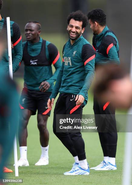 Mohamed Salah of Liverpool laughs during a training session at AXA Training Centre on May 25, 2022 in Kirkby, England.