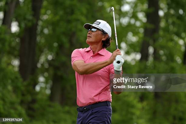 Ken Tanigawa of the United States watches his tee shot on the second hole during the first round of the Senior PGA Championship presented by...