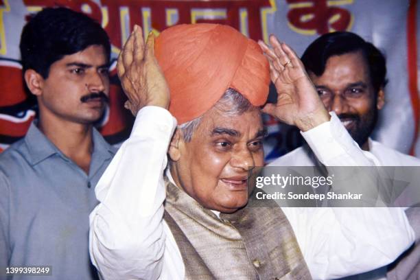 Prime Miniser Atal Behari Vajpayee holds a turban presented to him as a mark of respect in New Delhi April 05, 2000.