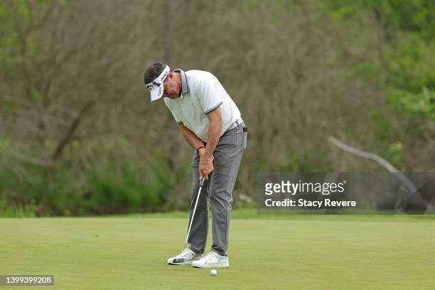 Rich Beem of the United States lines up a putt on the first green during the first round of the Senior PGA Championship presented by KitchenAid at...