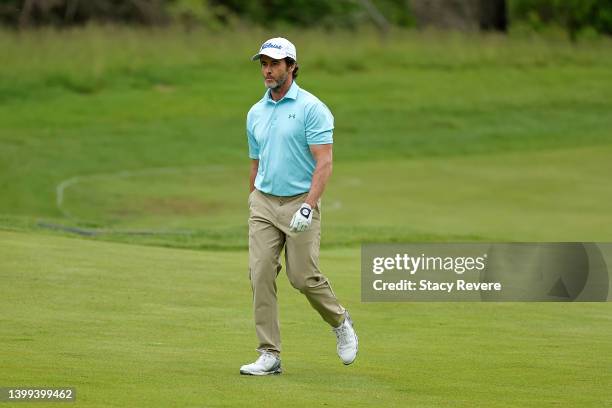 Mark Hensby of Australia walks to the first green during the first round of the Senior PGA Championship presented by KitchenAid at Harbor Shores...