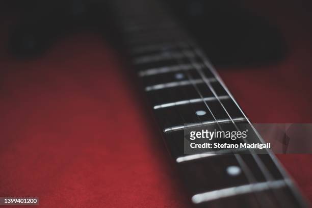 electric guitar handle on red background - red electric guitar stock pictures, royalty-free photos & images