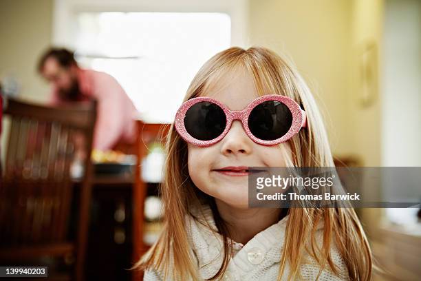 young girl wearing pink sunglasses in home smiling - 2 year old blonde girl father stock pictures, royalty-free photos & images
