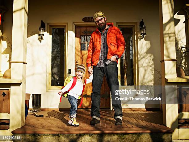 father and daughter on front porch of home - family porch foto e immagini stock