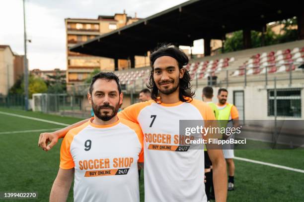 portrait of two soccer players near the bleachers - event sponsor stock pictures, royalty-free photos & images