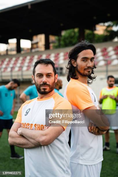 portrait of two soccer players near the bleachers - event sponsor stock pictures, royalty-free photos & images