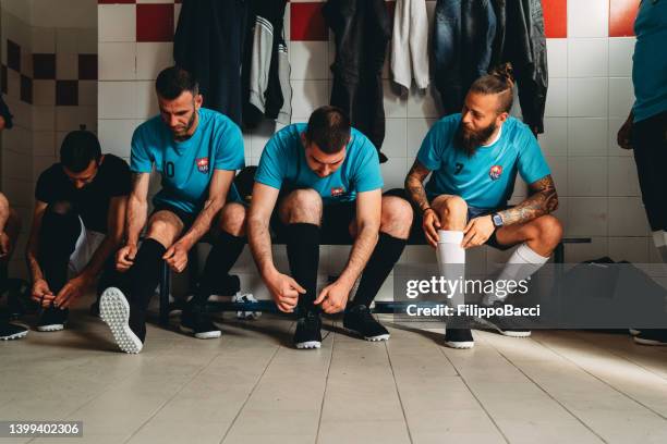 soccer team players are getting ready in the changing room before the match - mens changing room stock pictures, royalty-free photos & images