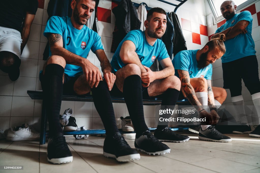 Fußballspieler bereiten sich vor dem Spiel in der Umkleidekabine vor