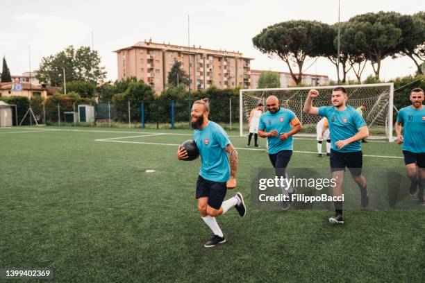 players of a soccer team are celebrating together after a goal - sportswear logo stock pictures, royalty-free photos & images