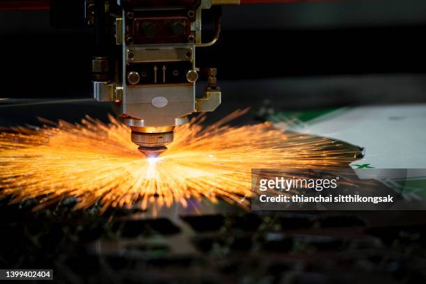 image of high-tech metal cutting laser tool in operation. - manufactured object stockfoto's en -beelden
