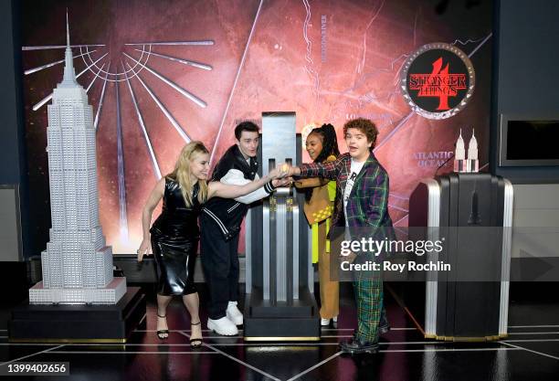 Cara Buono, Noah Schnapp, Priah Ferguson and Gaten Matarazzo of the Stranger Things cast participate in a lighting ceremony at The Empire State...