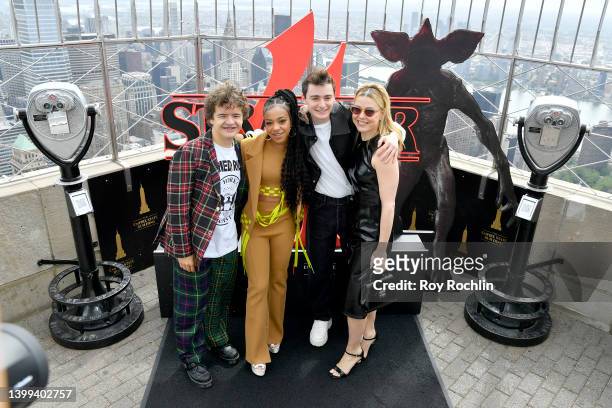 Gaten Matarazzo, Priah Ferguson, Noah Schnapp and Cara Buono of the Stranger Things cast visit The Empire State Building on May 26, 2022 in New York...