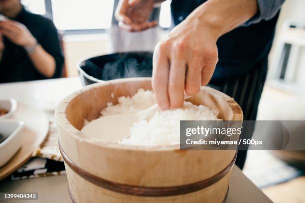 japanese traditional white rice,woman preparing food in kitchen - white rice stock pictures, royalty-free photos & images