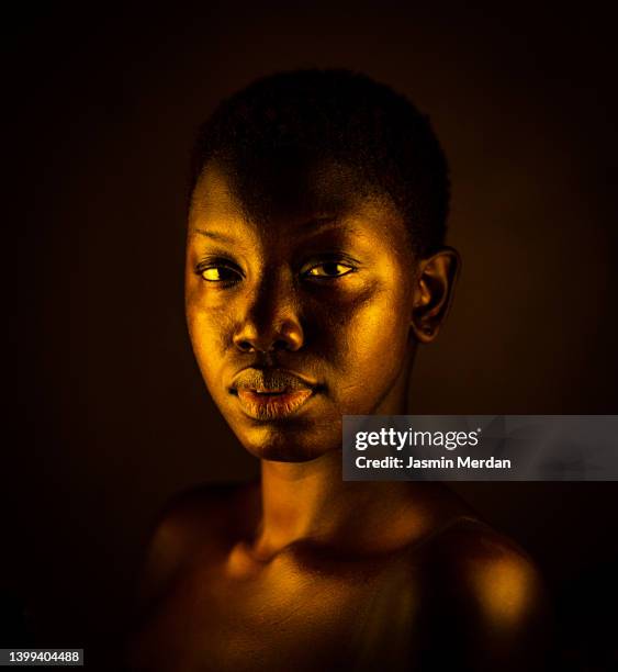 golden black african young woman with short hair - stern gold stock pictures, royalty-free photos & images