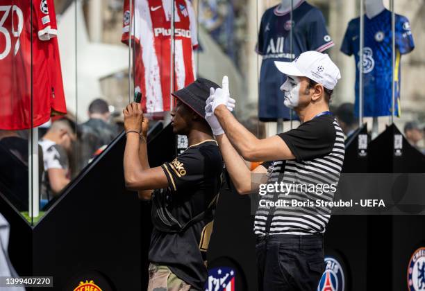 Mime makes jokes with fans at Hotel de Ville on day 1 of the UEFA Champions League Final 2021/22 Festival ahead of the UEFA Champions League final...