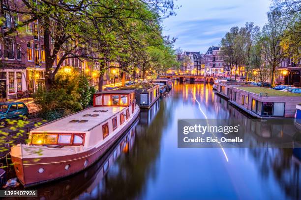 canal de la ville d’amsterdam avec groupe de péniches au crépuscule - amsterdam photos et images de collection