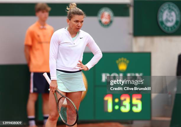 Simona Halep of Romania reacts against Qinwen Zheng of China during the Women's singles Second Round on Day Five of the 2022 French Open at Roland...