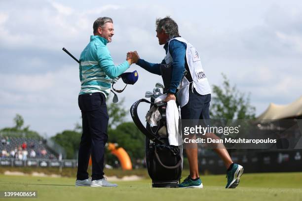 Mikko Korhonen of Finland celebrates making an eagle on the 18th hole with Caddie, Nick Mumford during Day One of the Dutch Open at Bernardus Golf on...