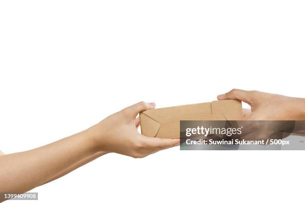 hand giving package of parcel isolated in clipping path,thailand - giving a box ストックフォトと画像