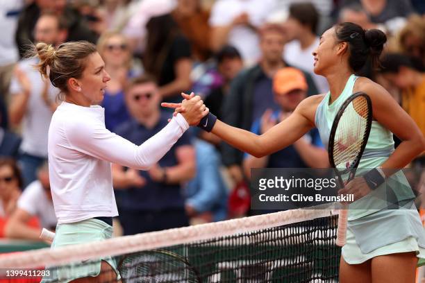 Simona Halep of Romania shakes hands with Qinwen Zheng of China following the Women's singles Second Round on Day Five of the 2022 French Open at...