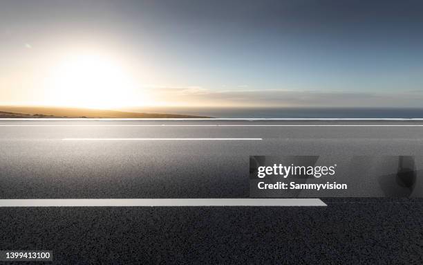 coastal highway against sunlight - two lane highway stock pictures, royalty-free photos & images